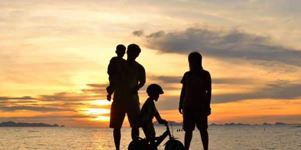 Silhouette image of a family by water | W8 Advisory | Family wealth management for African families